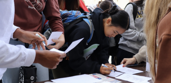 Students fill out their ballots at the at the Mock Election.